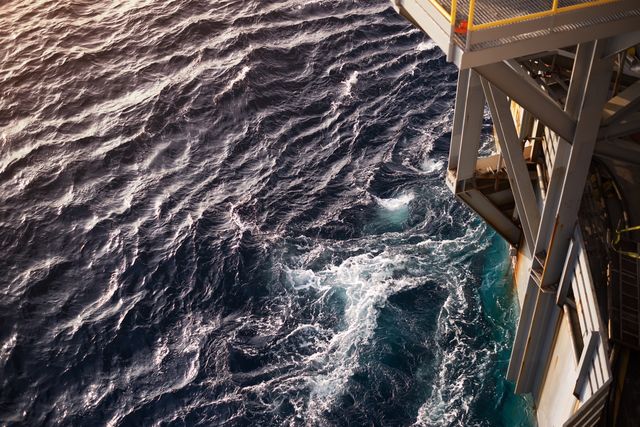 looking down towards ocean from top of an offshore rig