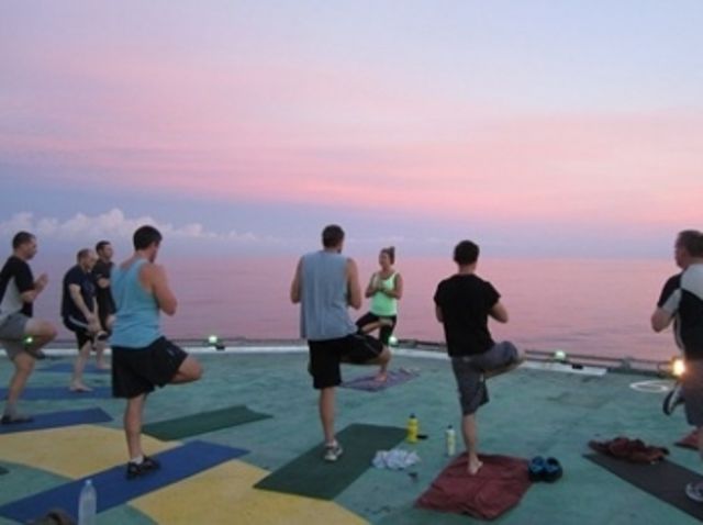 People exercising on top of an offshore rig