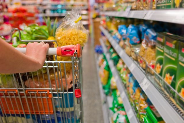 a shopping trolley in a supermarket aisle