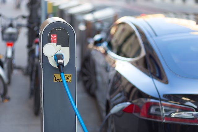 an electric car charging by the roadside