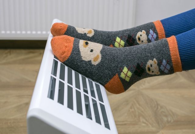 warming feet close to an electric heater