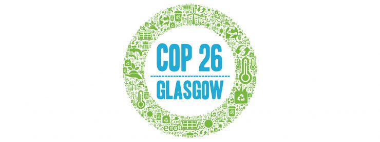 An illustration shows a green circle comprised of icons of sustainability. A blue title in the middle of the circle reads, "COP 26 Glasgow".